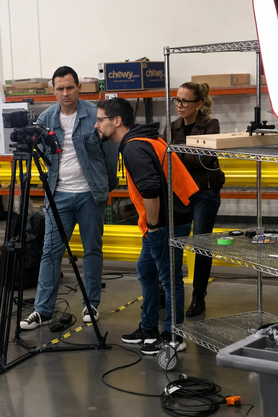 Michael Carpenter, in the denim jacket, directing a shot at a Chewy facility in Dallas