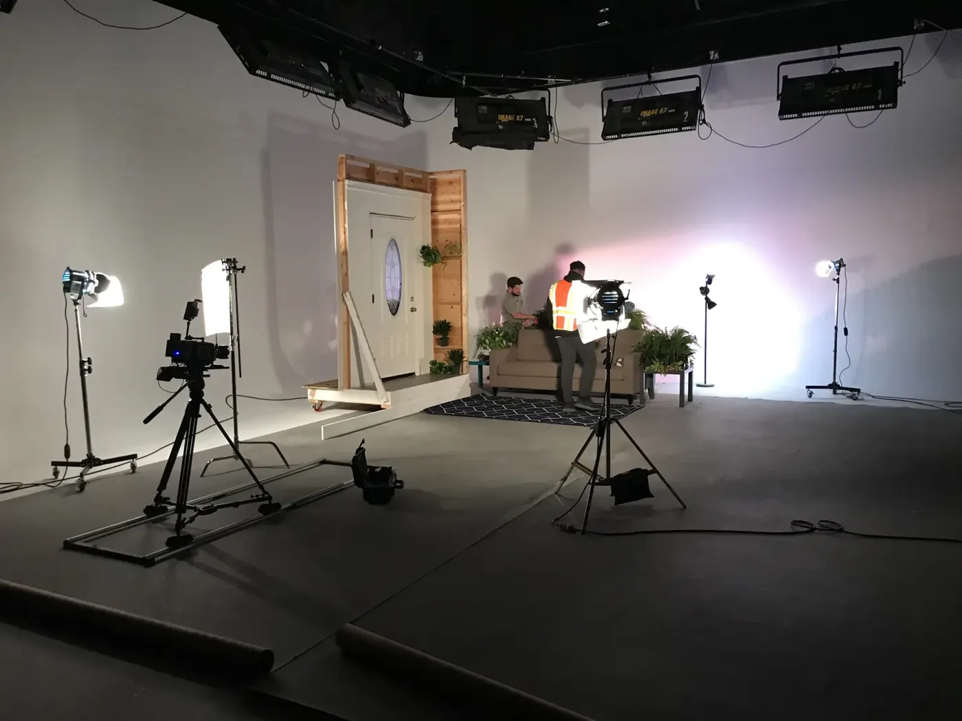 Freestanding door set with camera slider and lighting on a commercial soundstage